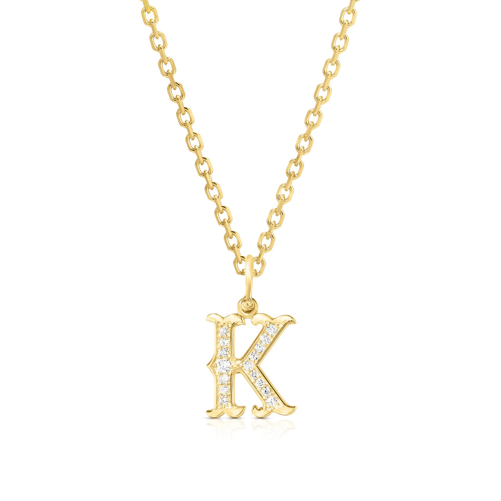 Front view of Western K initial pendant in 14k yellow gold with pave sparkling stones on a gold chain against white background