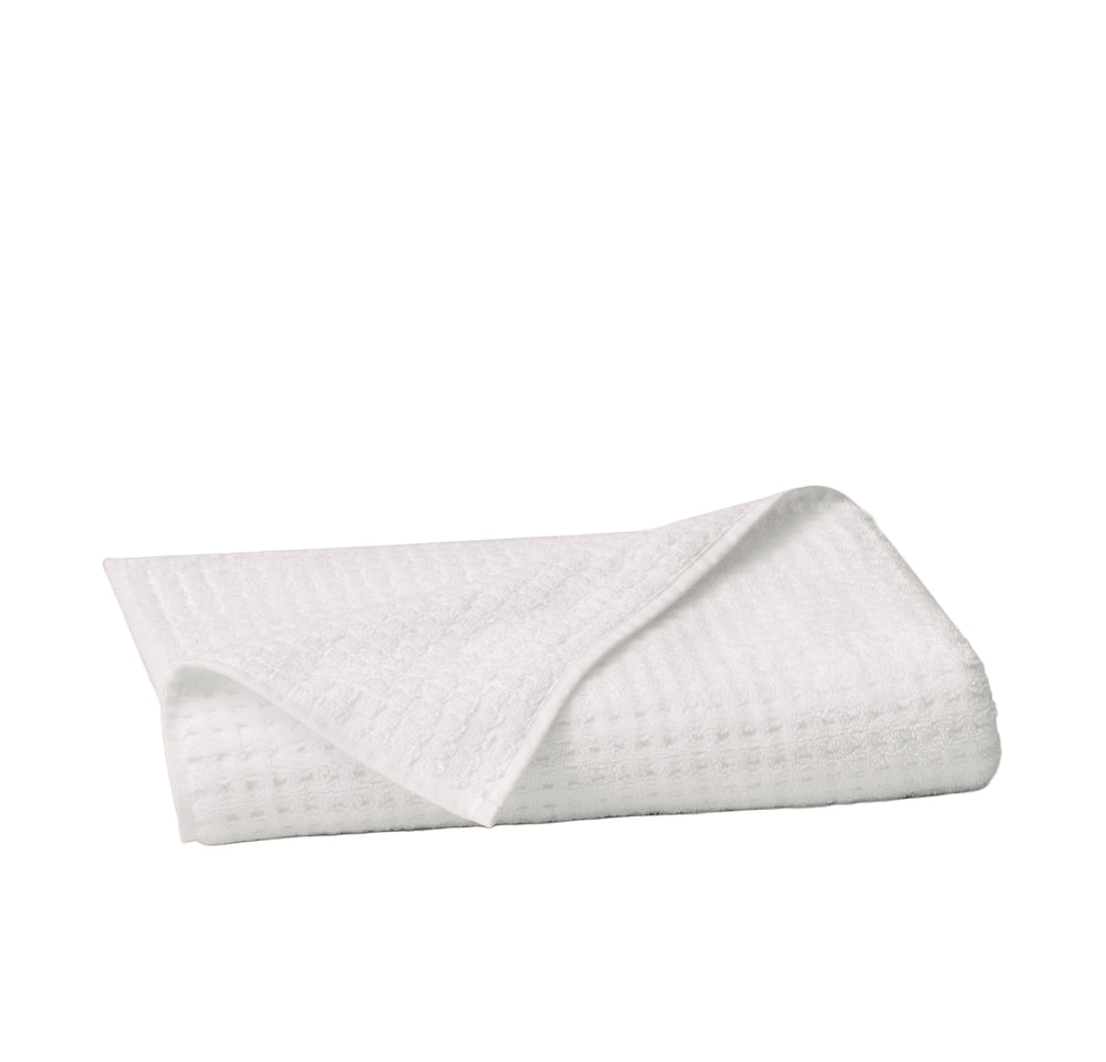 Folded Turkish waffle bath towel showcasing waffle weave texture on white background