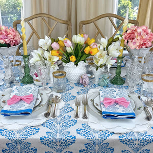 Elegant table setting with floral centerpieces, blue and white tablecloth, and decorative napkins. Vegan leather easy clean 
white placemats