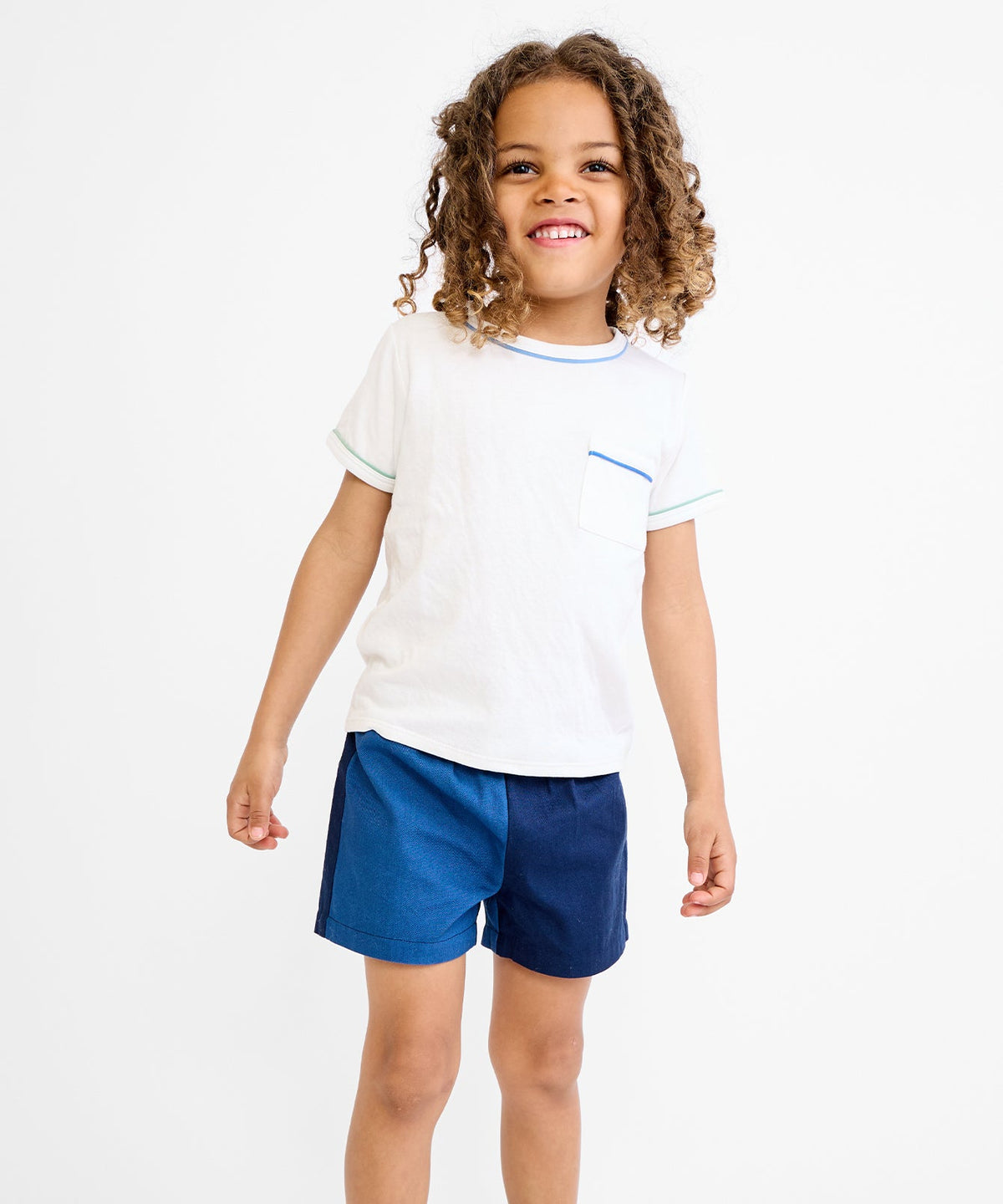 Front view of Willie T-Shirt in Cool Piping showcasing contrast piping at the pocket, sleeves, and neckline on a child against a white background