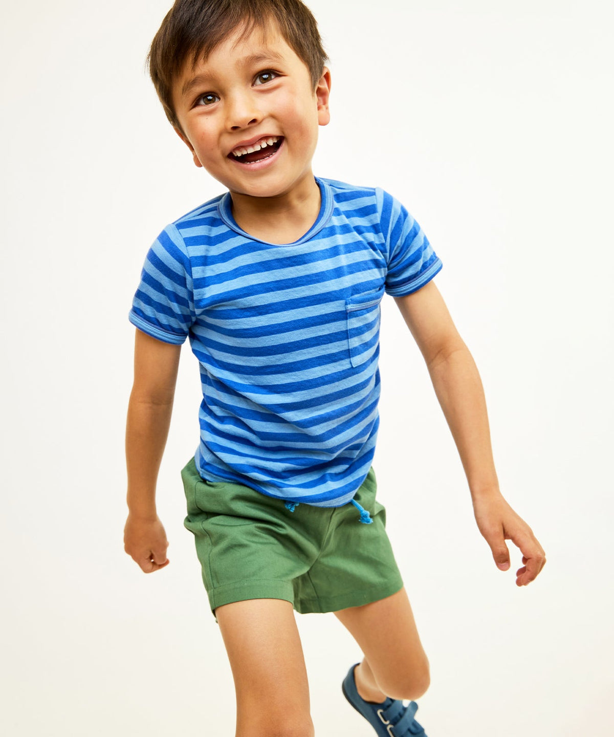 Front view of Willie T-Shirt in Indigo Stripe showcasing chest pocket and contrast piping with a child model against a white background