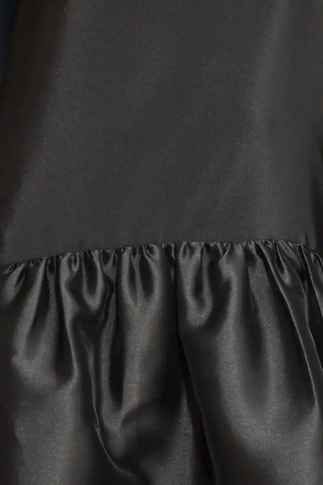 The Windsor Dress has a sleeveless silhouette with a crew neckline, dropped waist with bubble skirt.