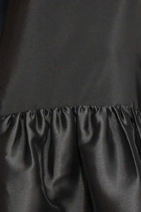 The Windsor Dress has a sleeveless silhouette with a crew neckline, dropped waist with bubble skirt.