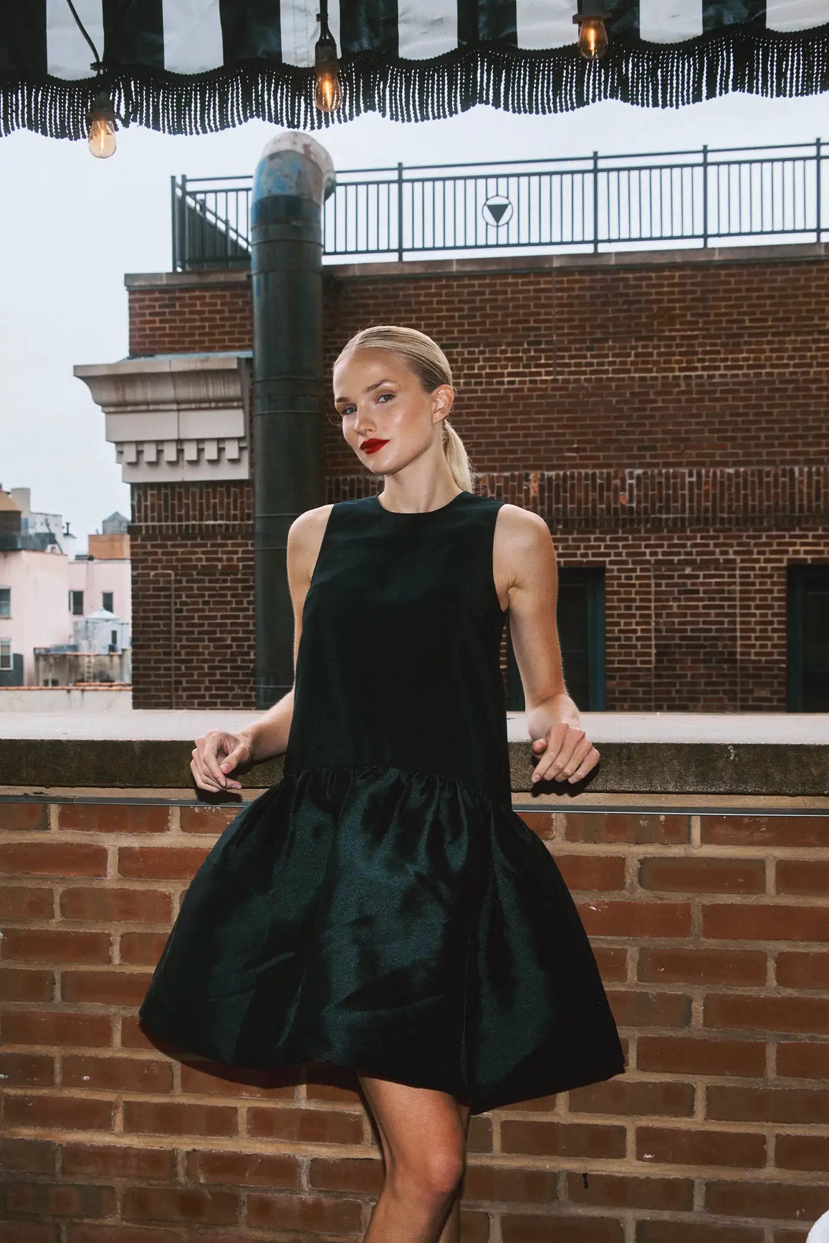 The Windsor Dress has a sleeveless silhouette with a crew neckline, dropped waist with bubble skirt.