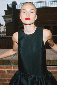 The Windsor Dress has a sleeveless silhouette with a crew neckline, dropped waist with bubble skirt.