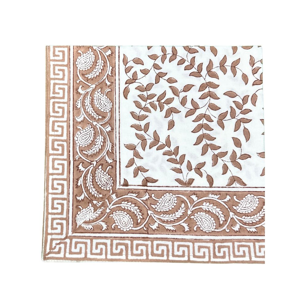 Decorative cloth napkin with brown and white leaves patterns on a white background