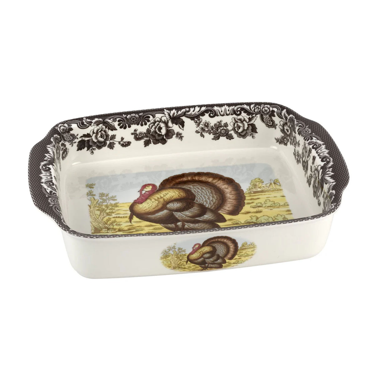 Angled view of Woodland Turkey handled lasagne dish showcasing painted turkey motif, floral rim border, and side handles on white porcelain