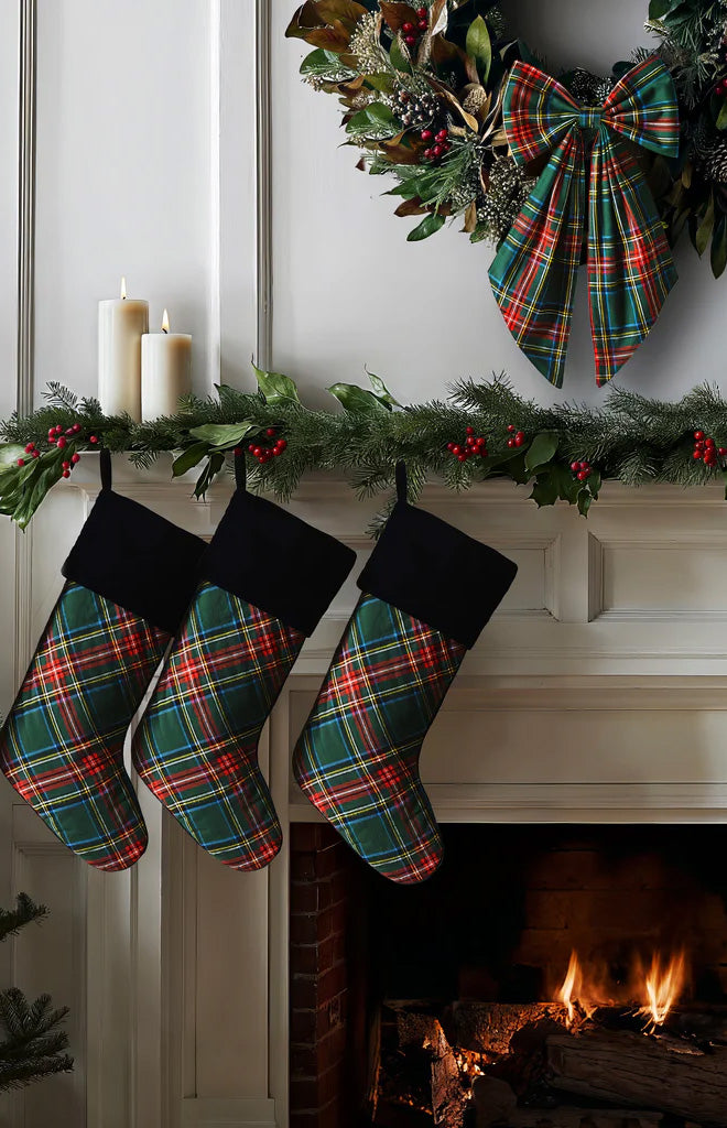 Front view of Wreath Bow in Kensington Tartan showcasing its tartan print on a holiday wreath above a fireplace