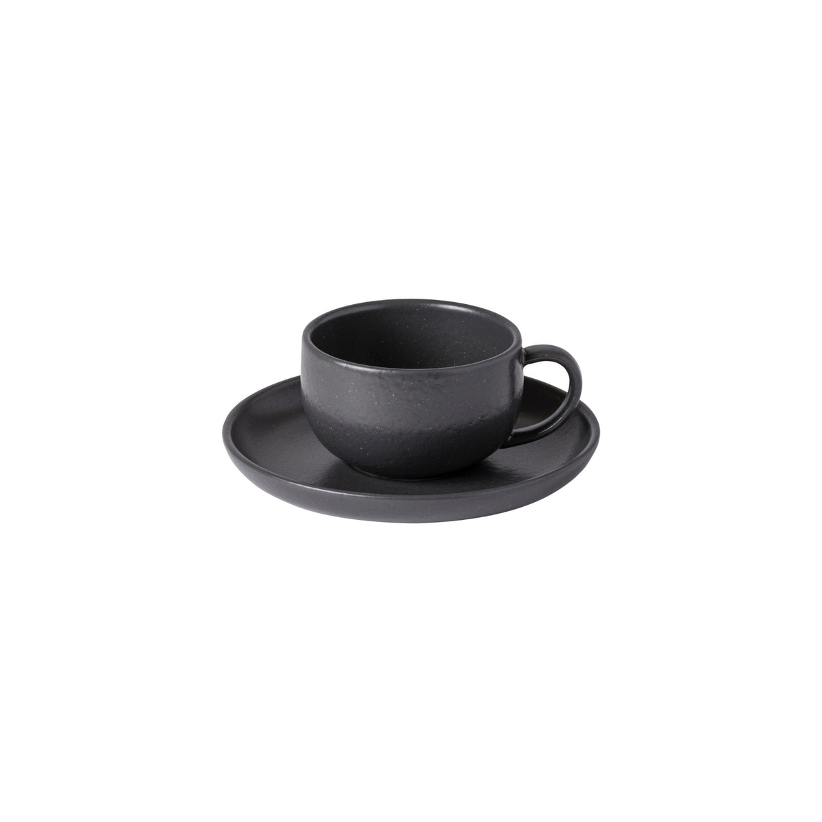 Three-quarter view of Pacifica teacup and saucer in seed grey showcasing matte glaze and simple rounded silhouette on white background