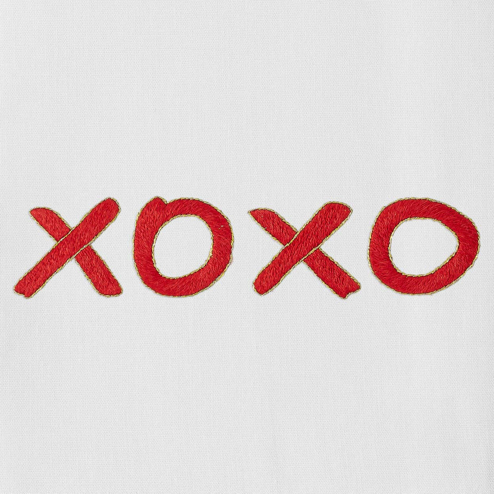 Close-up of XOXO hand towel showcasing red hand-embroidered XOXO on white cotton