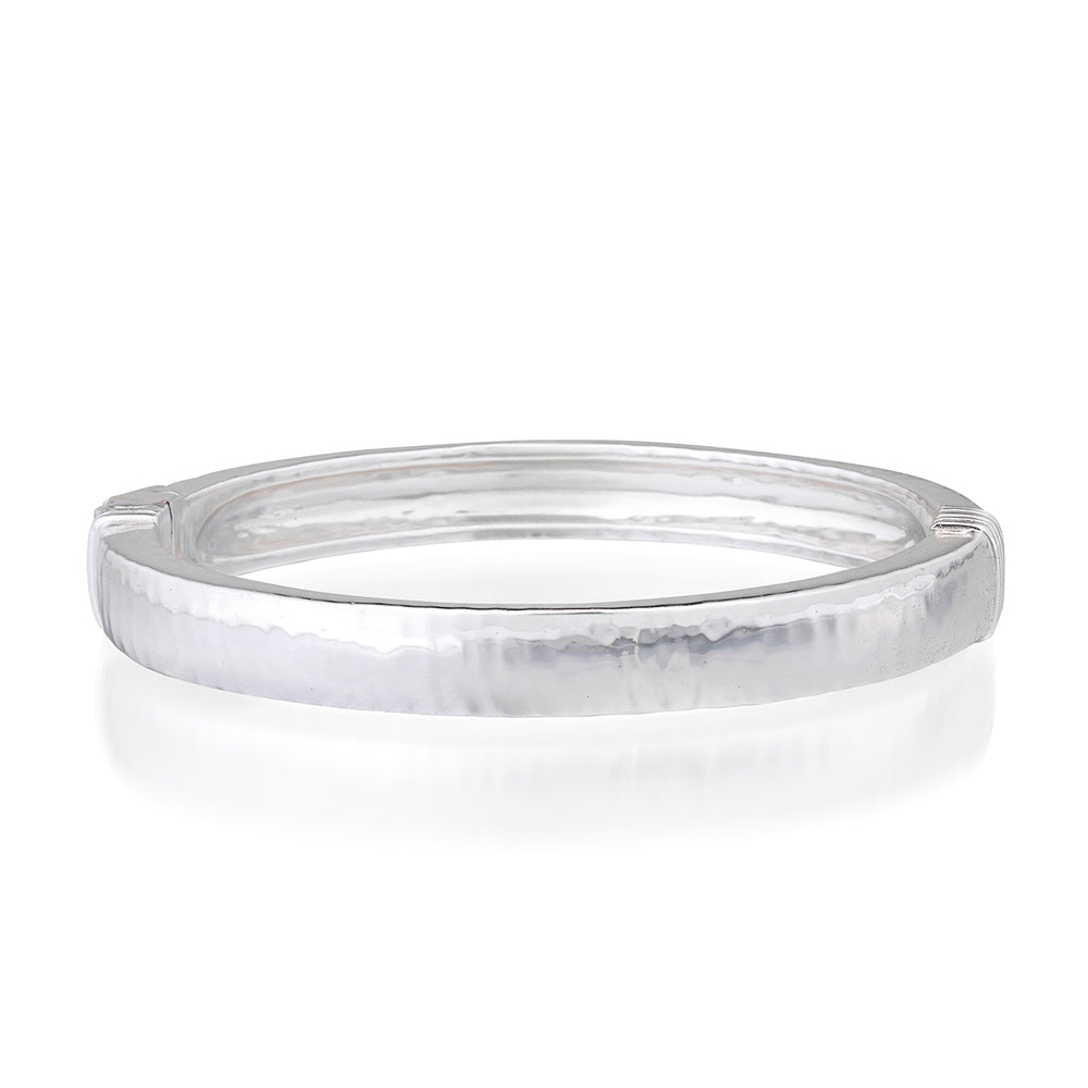 Three-quarter view of Cleopatra Oval Hinged Bangle in Silver showcasing its hammered finish and hinged ends on a white background