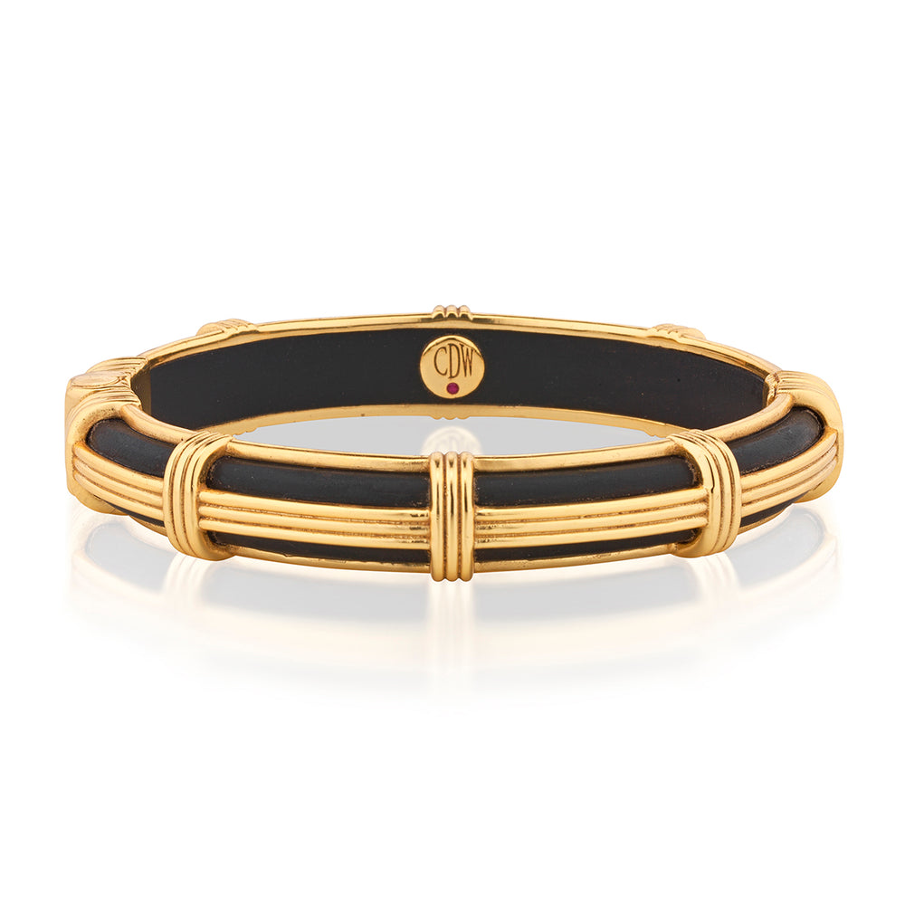 Front view of the Gaia Petite Hinged Bangle in Ebony showcasing ebony wood with gold accents on a white background