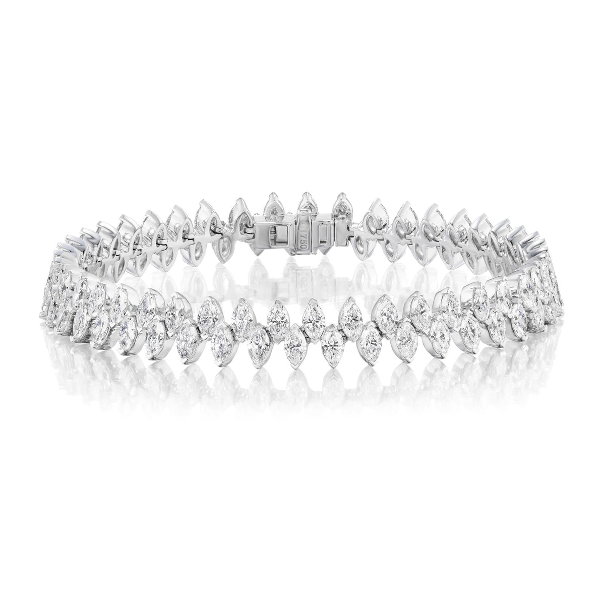 The Alternating Marquise Diamond Tennis Bracelet in White Gold features two rows of SI clarity marquise diamonds, beautifully set in 18k white gold and elegantly displayed on a white reflective surface.
