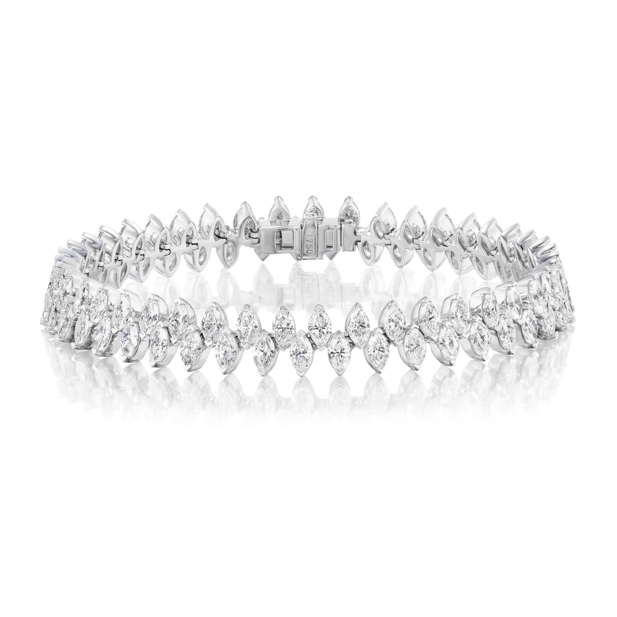 The Alternating Marquise Diamond Tennis Bracelet in White Gold features two rows of SI clarity marquise diamonds, beautifully set in 18k white gold and elegantly displayed on a white reflective surface.