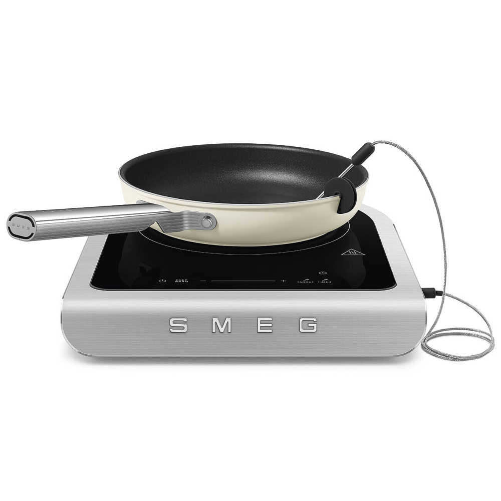 Front view of SMEG portable induction cooker showcasing an external temperature probe and pan on a white background