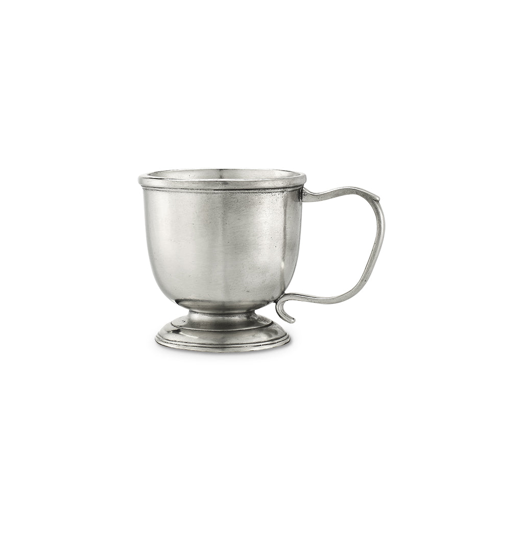 Front view of Match baby cup showcasing pewter finish, curved handle and pedestal base on white background