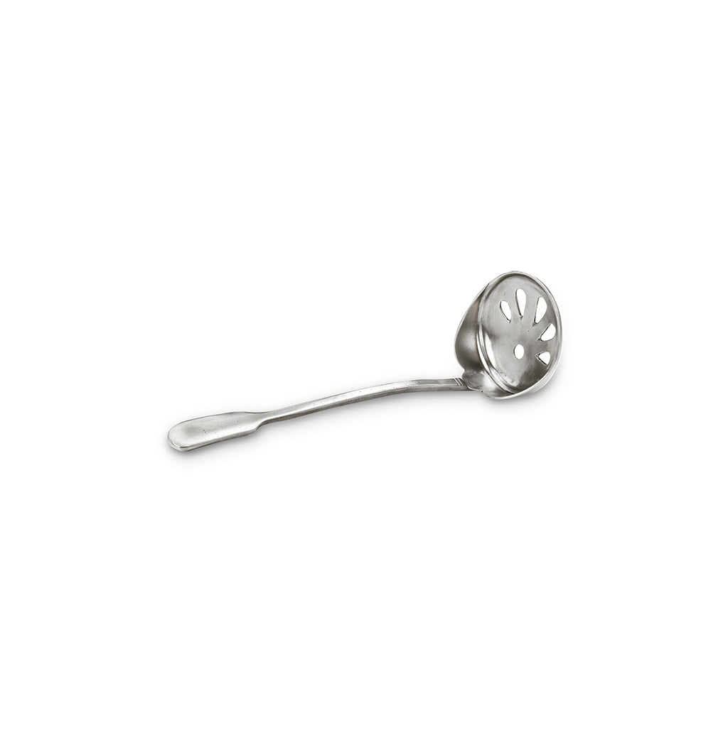 Angled view of pewter ice scoop with slotted bowl and long handle on white background