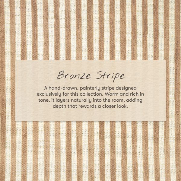 Close-up of All-Stages Bassinet Sheet in Autumn Stripe featuring warm bronze and cream vertical stripes with Bronze Stripe label