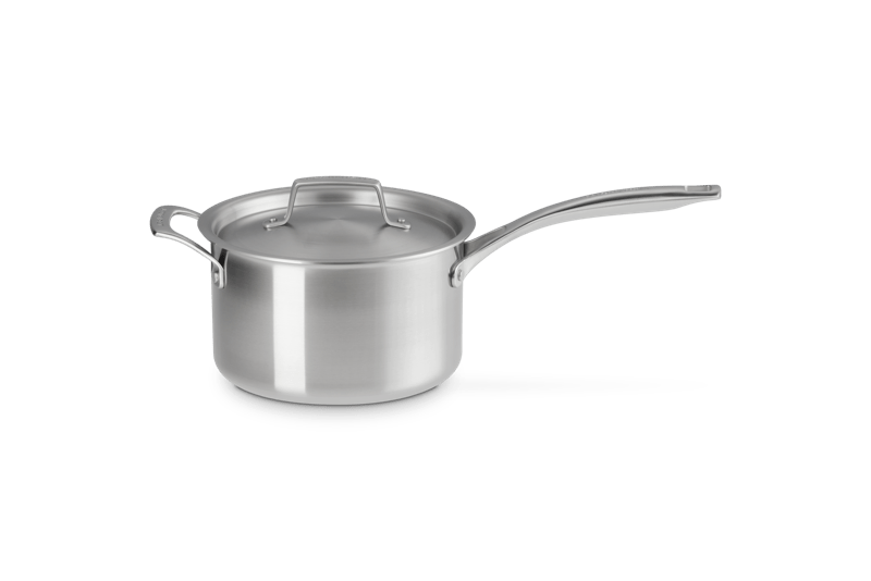 Front-left view of Essential stainless steel 4 qt saucepan showcasing brushed finish, lid, and long handle on white background