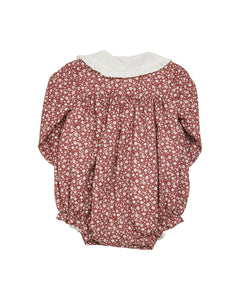 Floral baby romper with white collar on a white background