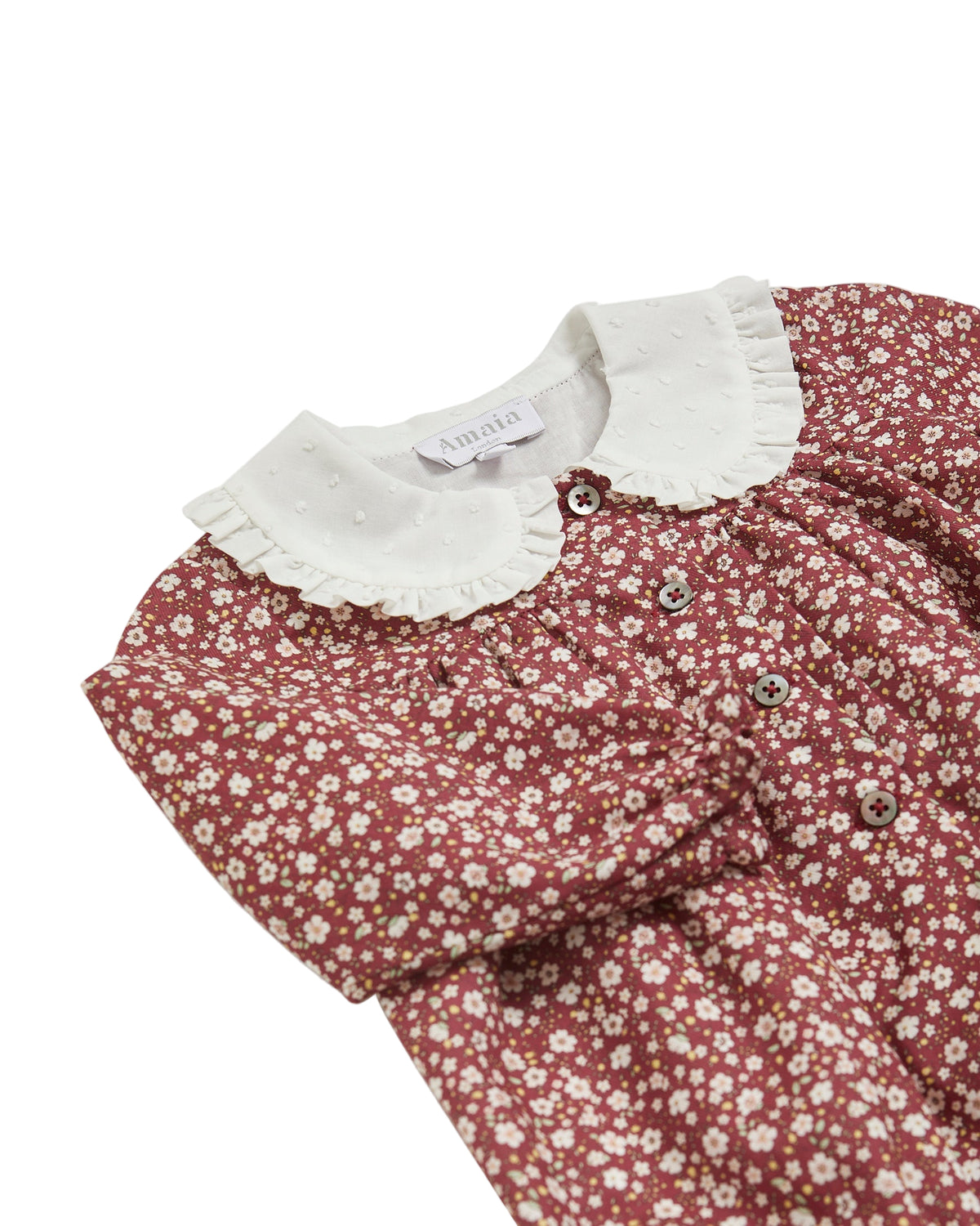 Floral baby dress with white collar on a white background