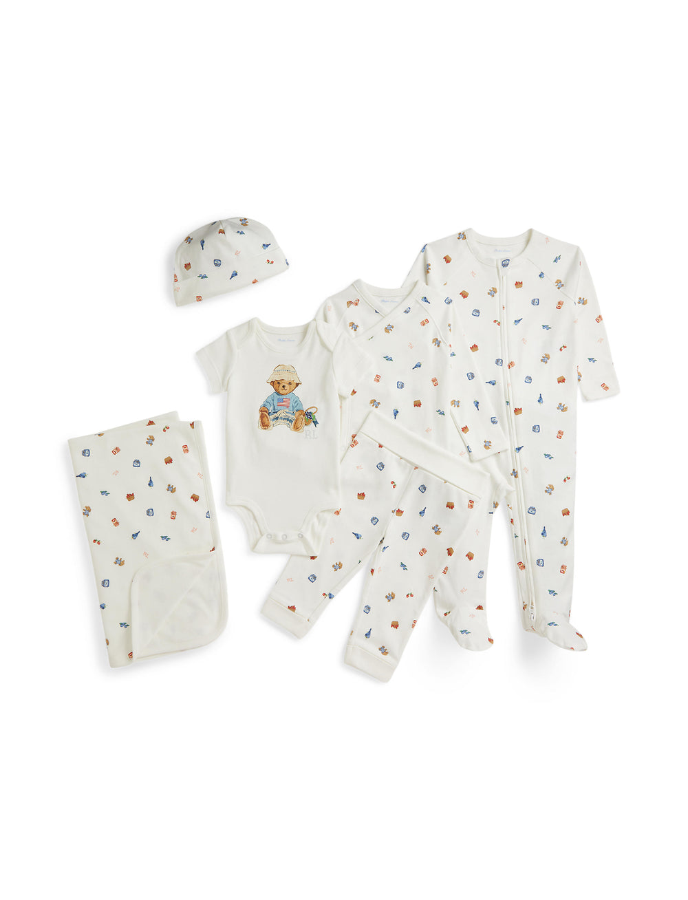 Flat lay of Berry Bear 6-piece baby set showing coverall, bodysuit, pants, shirt, hat, and blanket with small bear motif on white background