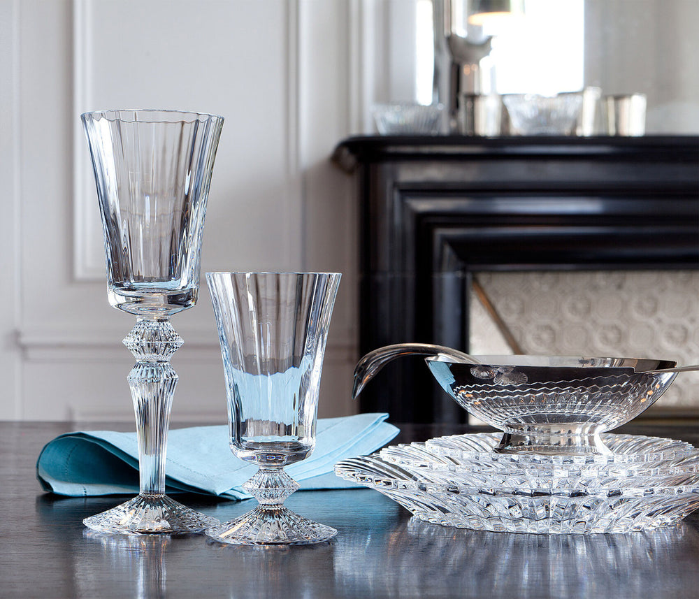 Mille Nuits large crystal plate stacked with a serving bowl, two crystal goblets, and a blue napkin on a table