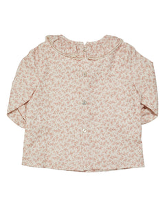 Floral patterned baby shirt on a white background