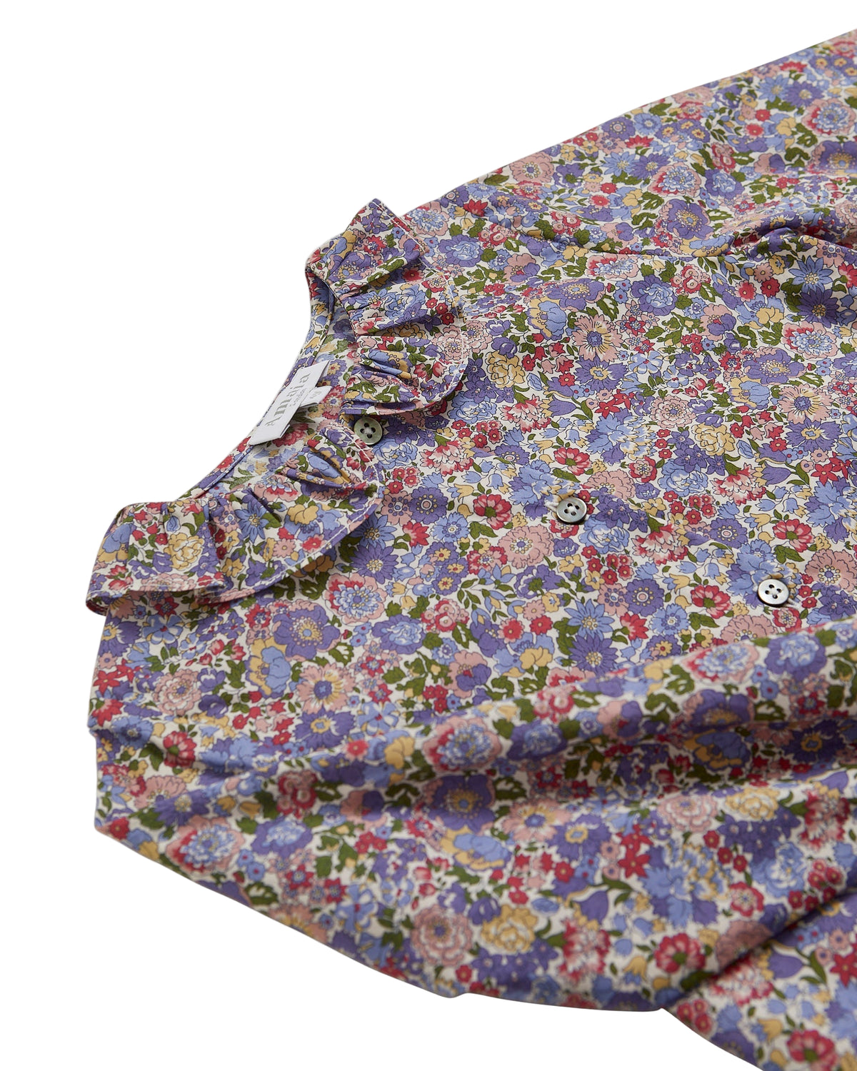 Floral patterned shirt with ruffled collar on a white background