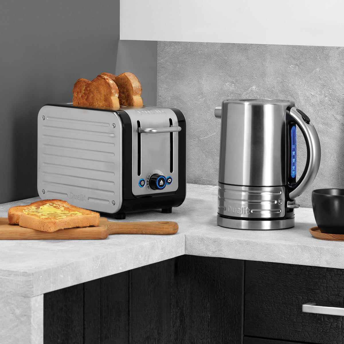 Front view of 2 Slot Design Series Toaster in Black and Stainless Steel showcasing two extra-wide slots with toast and a stainless steel kettle