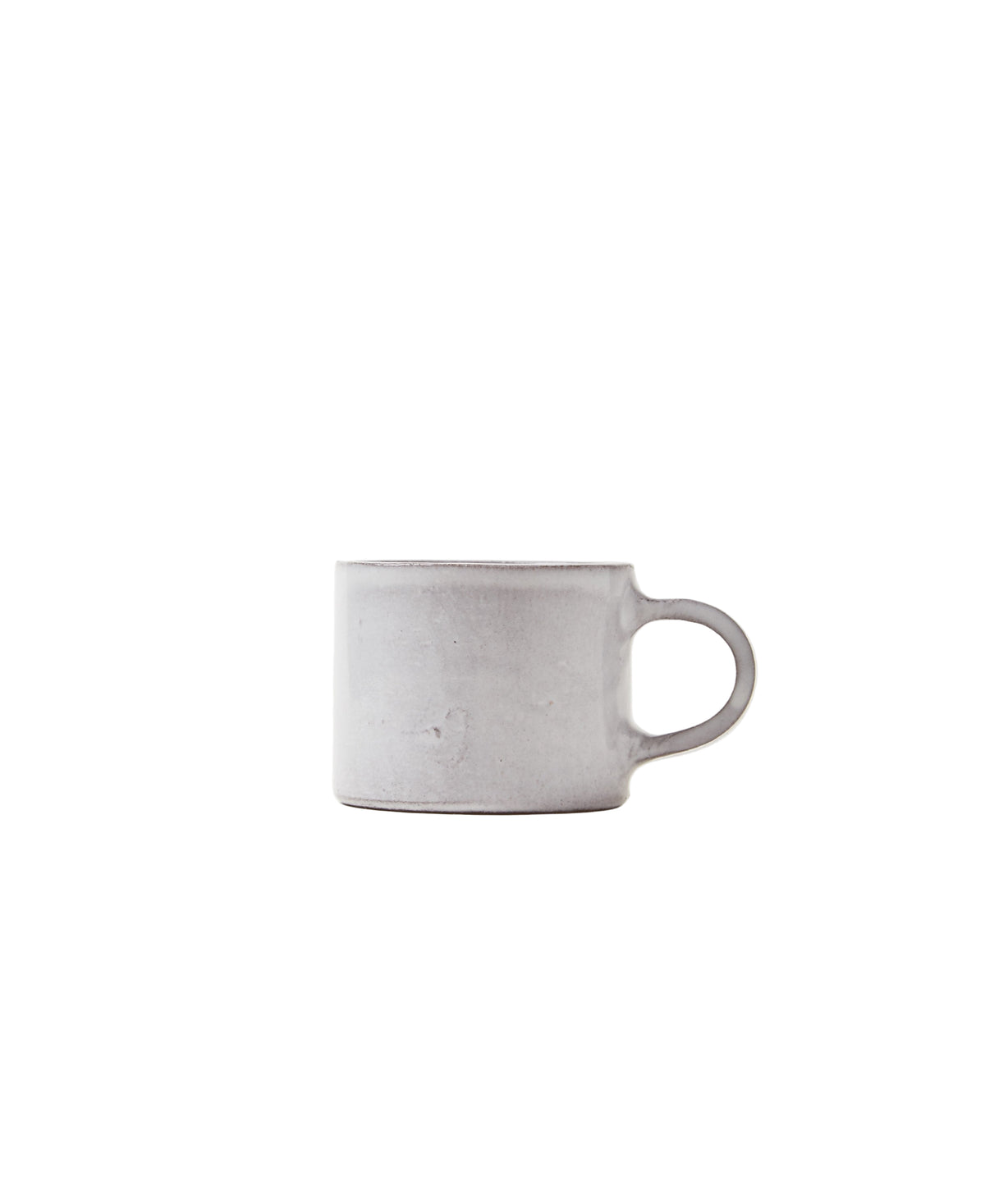 Side view of Assisi Espresso Cup showcasing matte bianco glaze and round loop handle on white background