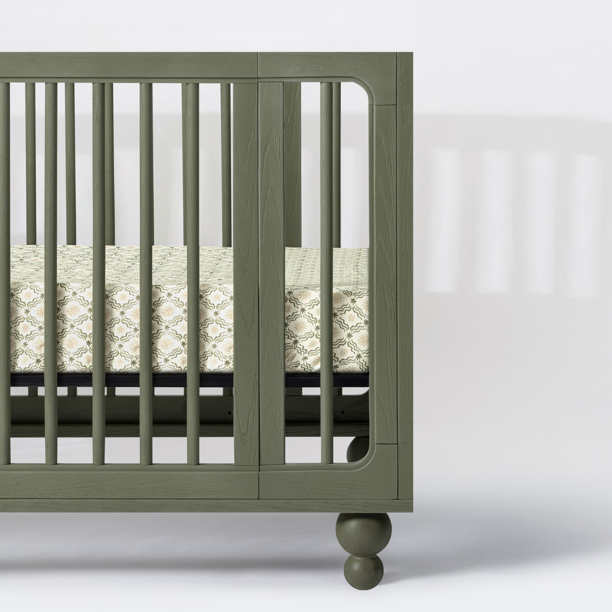 Close-up of Nate Berkus Juniper Star crib sheet showcasing its star pattern on a green crib