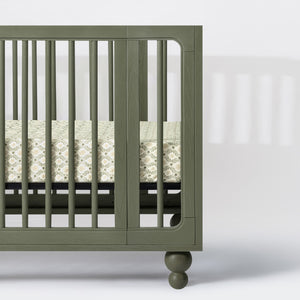 Close-up of Nate Berkus Juniper Star crib sheet showcasing its star pattern on a green crib