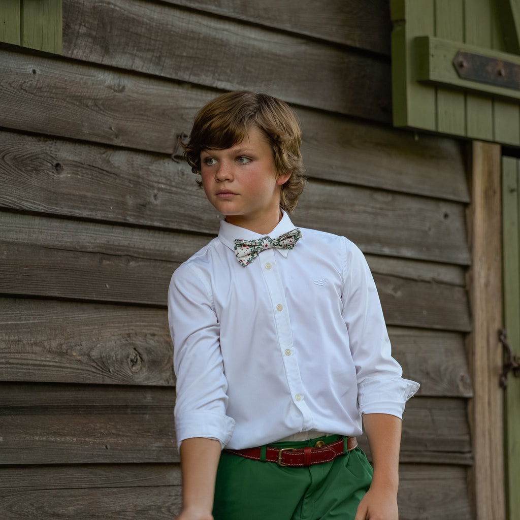 Boys’ Baker Bow Tie in Regent Wreaths, a festive red and green holiday print on a classic white background.