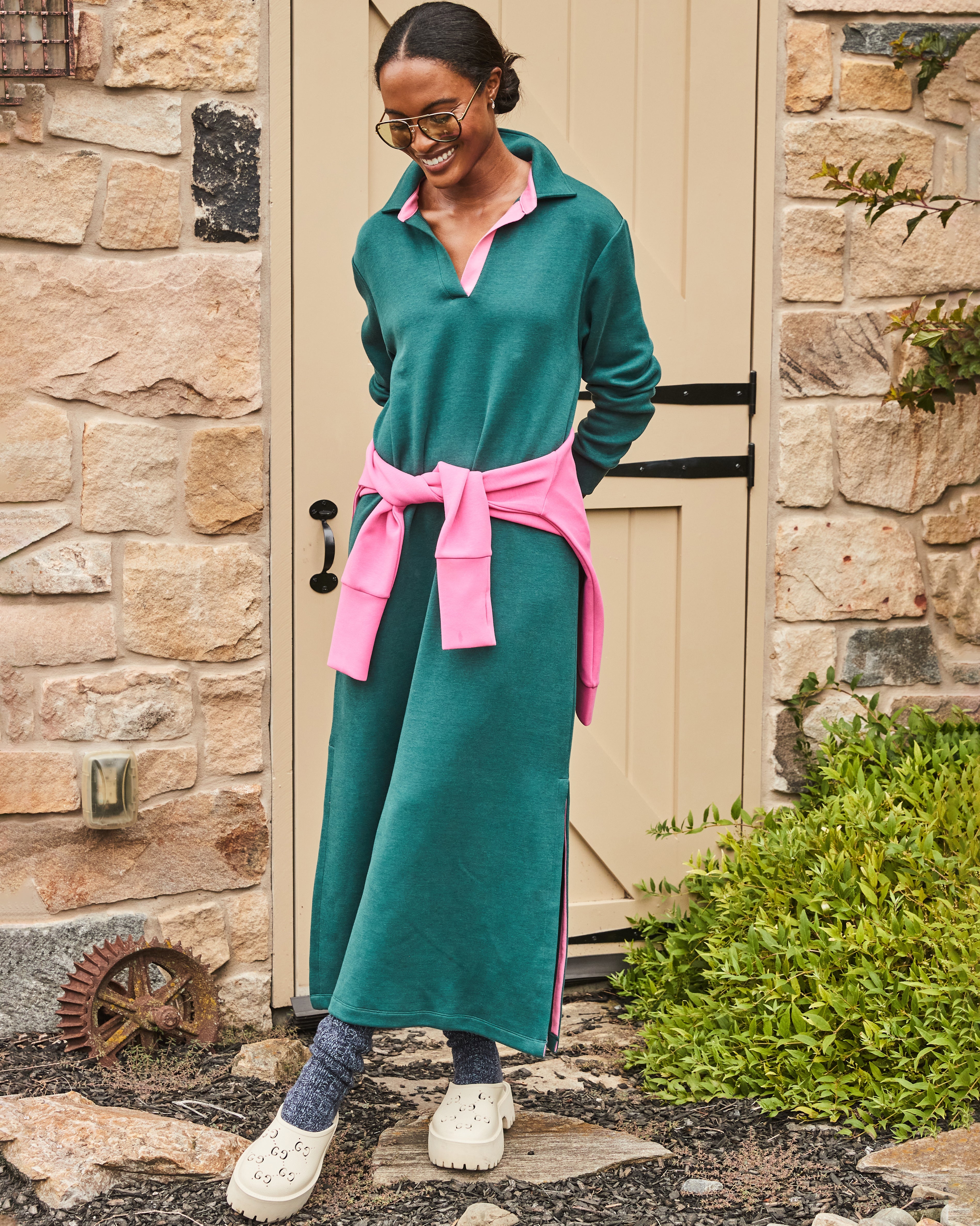 Model is wearing the Beck Dress in Ivy with the Everyday Pullover in Peony tied around her waist