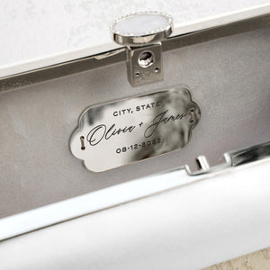 An engraved Personalized Plaque Sentiment Engraving with the names "Oliver & James" and the date "08-12-2022" attached to the interior of a Bella Rosa bag.