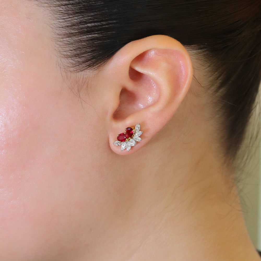 Close-up side view of Belle Ruby stud earring showing twin oval rubies and marquise-cut diamond petals on model’s ear