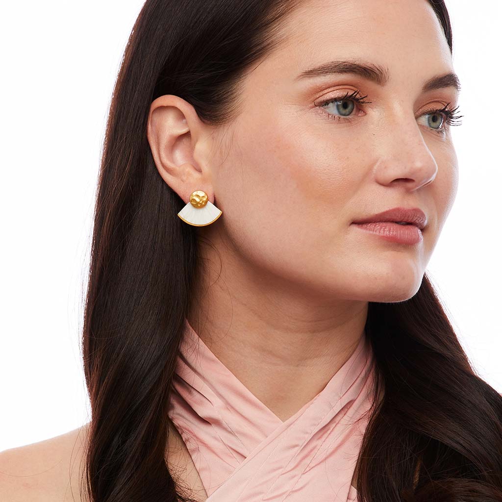 Right-side view of Bianca stud earring showing white feather fan and hammered gold stud on model against white
