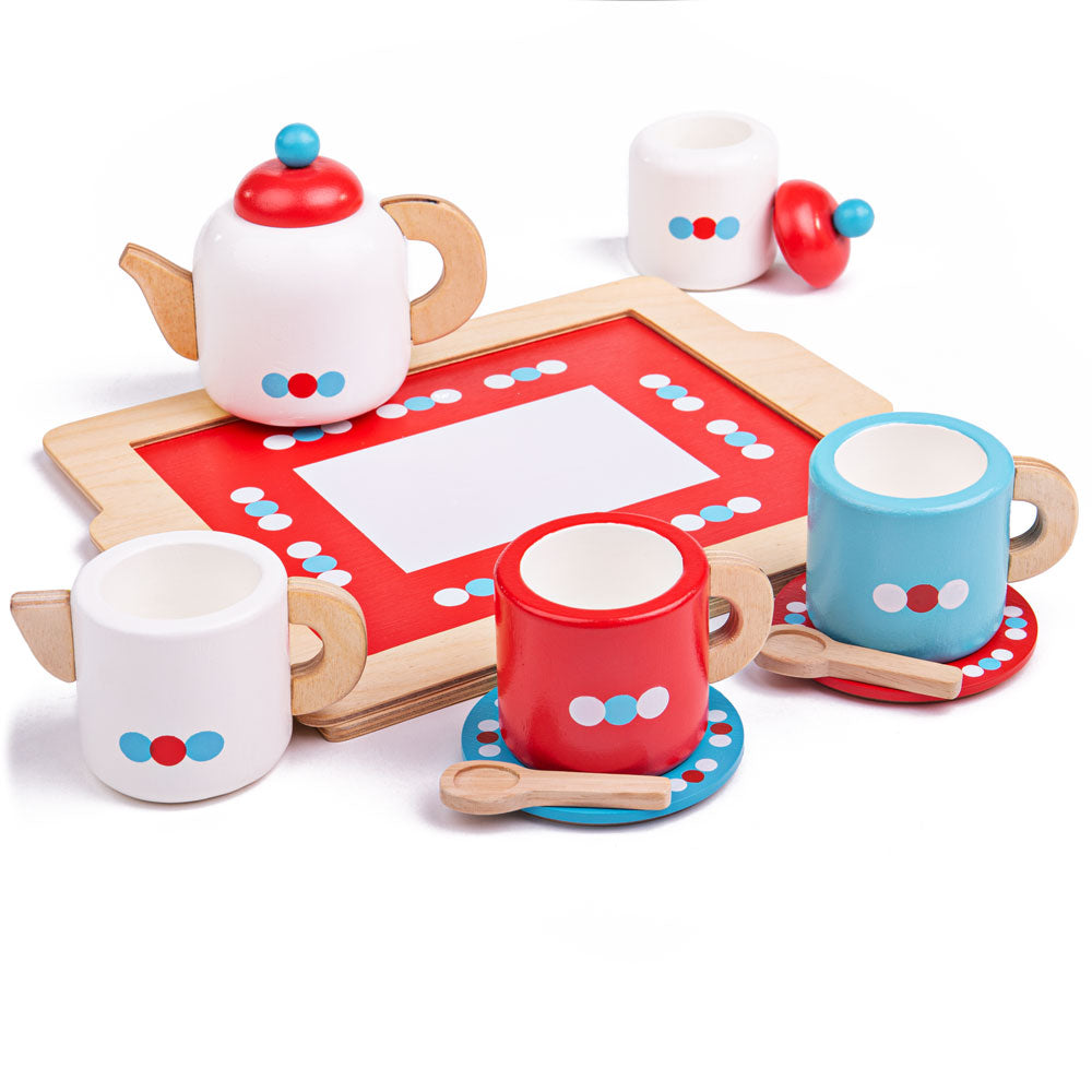 Three-quarter view of wooden kids tea set and tray showcasing colorful teapot, cups, saucers, spoons, milk jug, and sugar pot