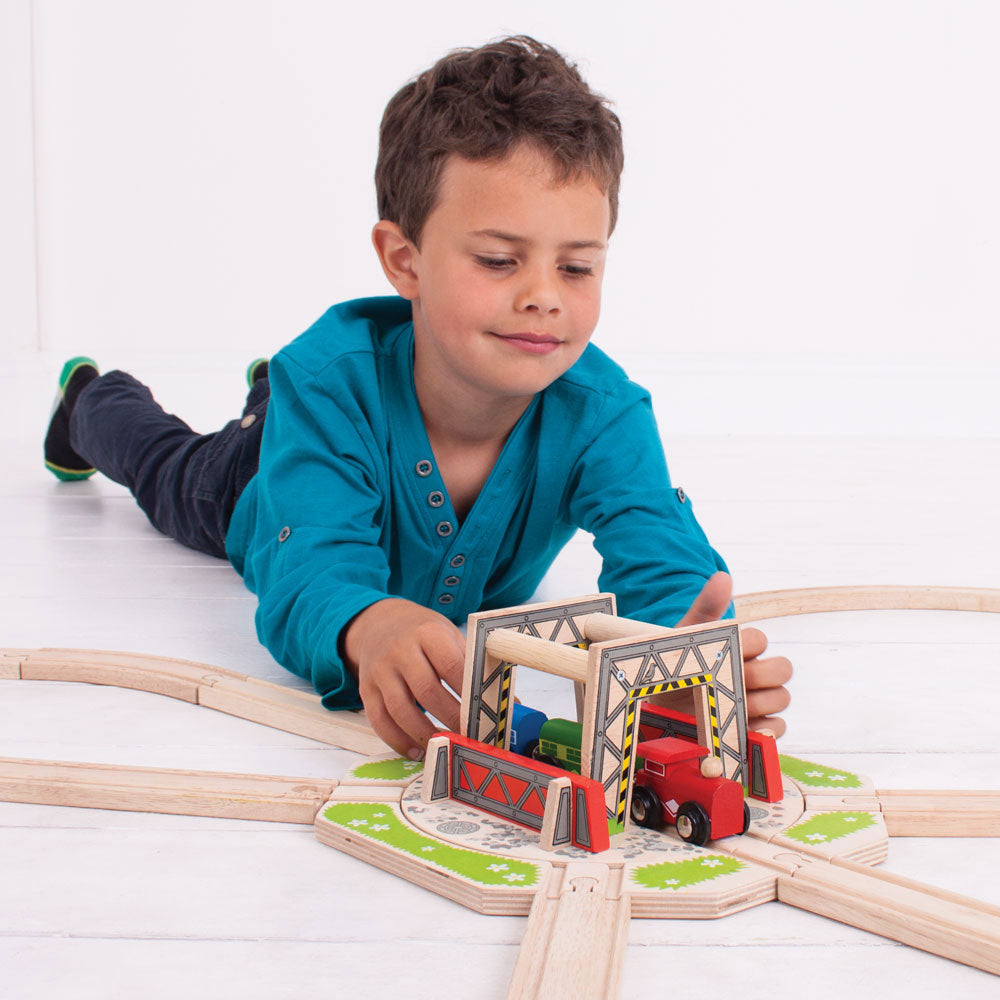 Child playing with the Industrial Turntable and wooden trains on a track layout