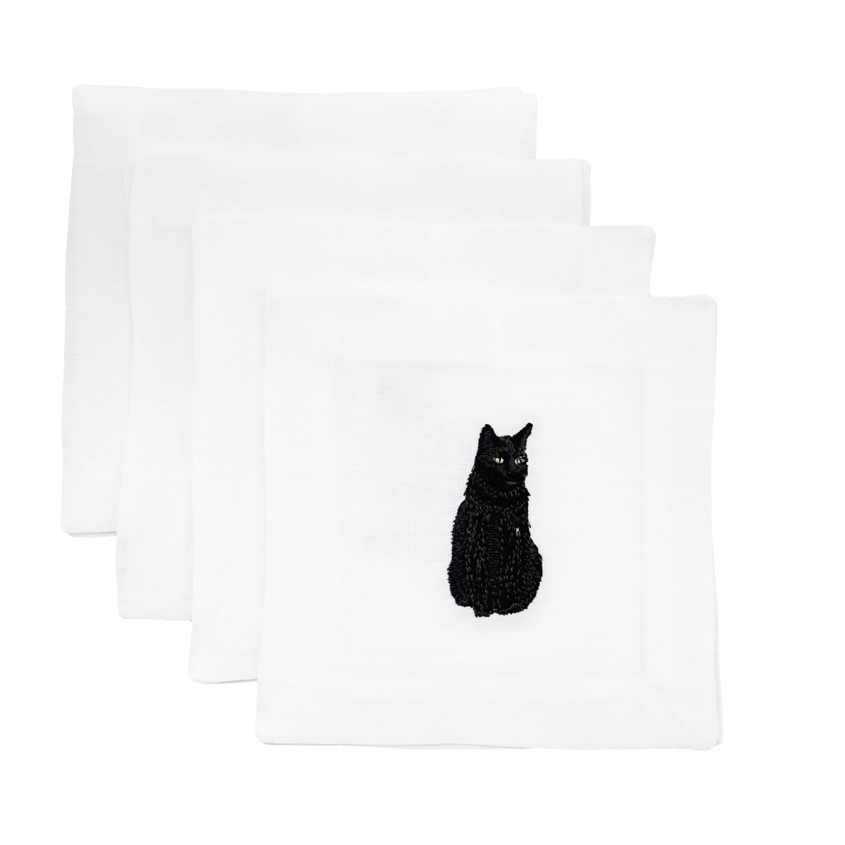 Front view of Cat Combo set of four white linen cocktail napkins showcasing embroidered black cat motif on white background