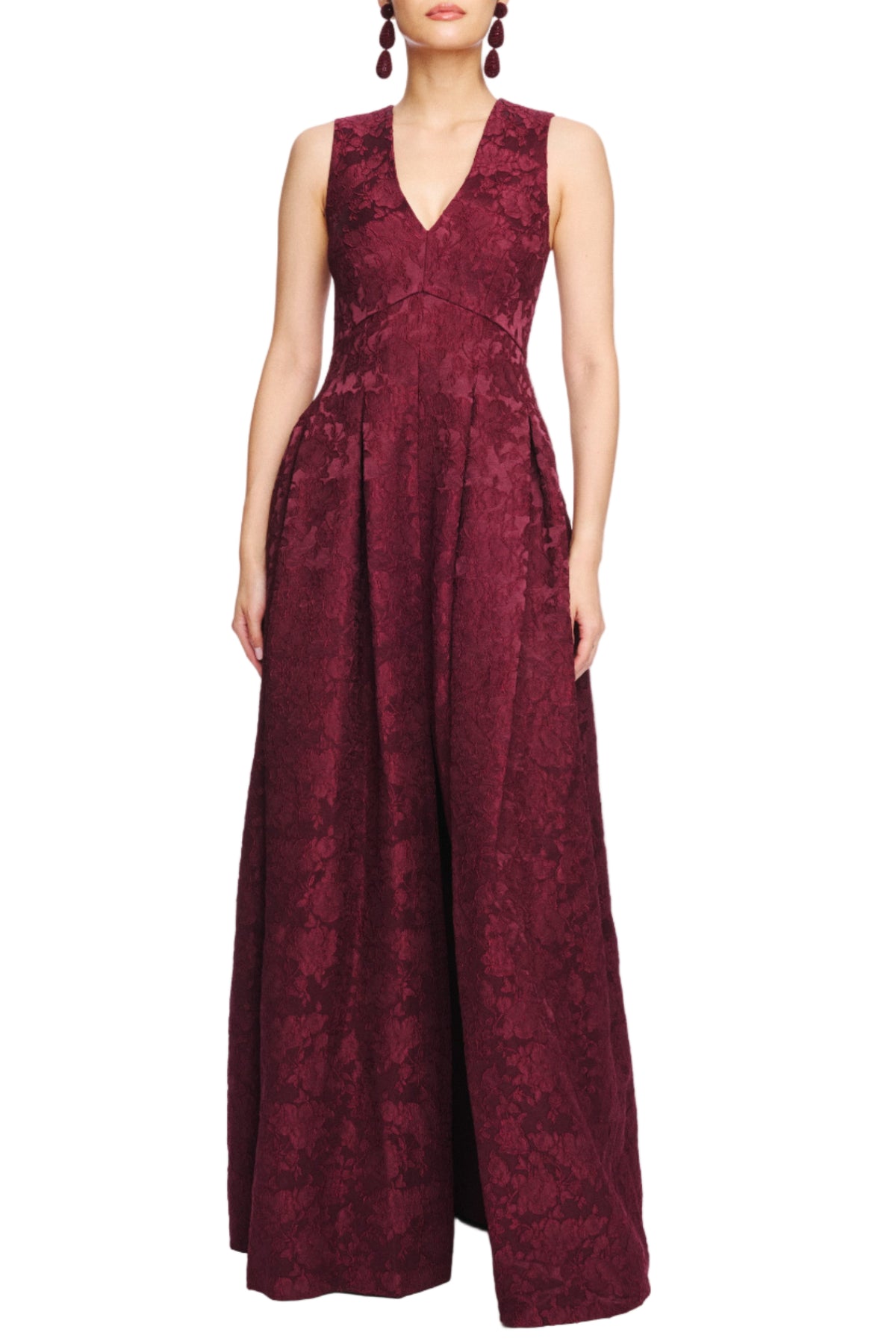 Front view of Brooke gown in Napa burgundy showcasing V-neck sleeveless bodice and full textured A-line skirt on white background