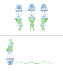 Decorative set with topiary trees, lanterns, and ribbons on a white background