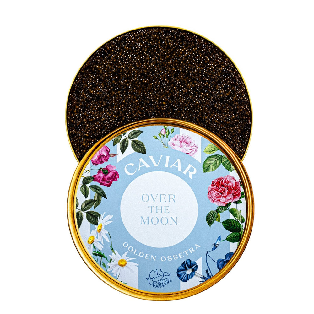 Top view of 1 kg Over The Moon Golden Ossetra caviar tin showing dark golden pearls and floral blue lid on white background