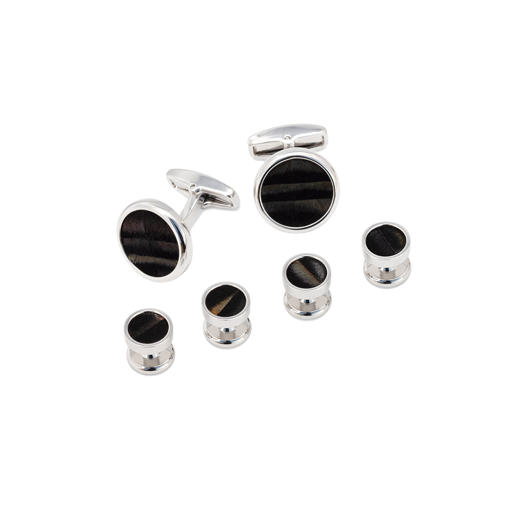 Angled front view of Chino cufflink and studs set showing natural black turkey feather inlays and polished silver finish on black background