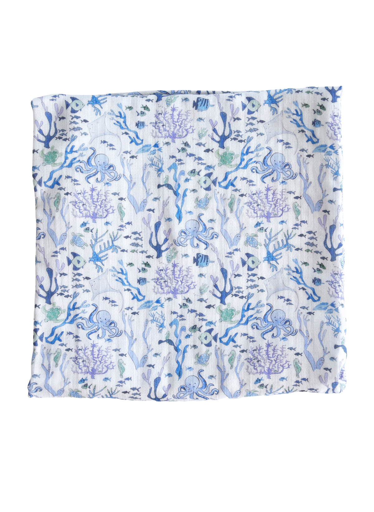 Flat lay of Coral Reef Shawl Blanket showing blue and purple coral reef and sea creature print on white organic cotton fabric