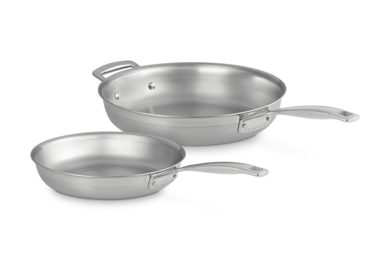 Angled view of Classic 2-piece stainless steel frying pan set showing satin-matte finish, riveted handles, and precision-sealed rims on white background