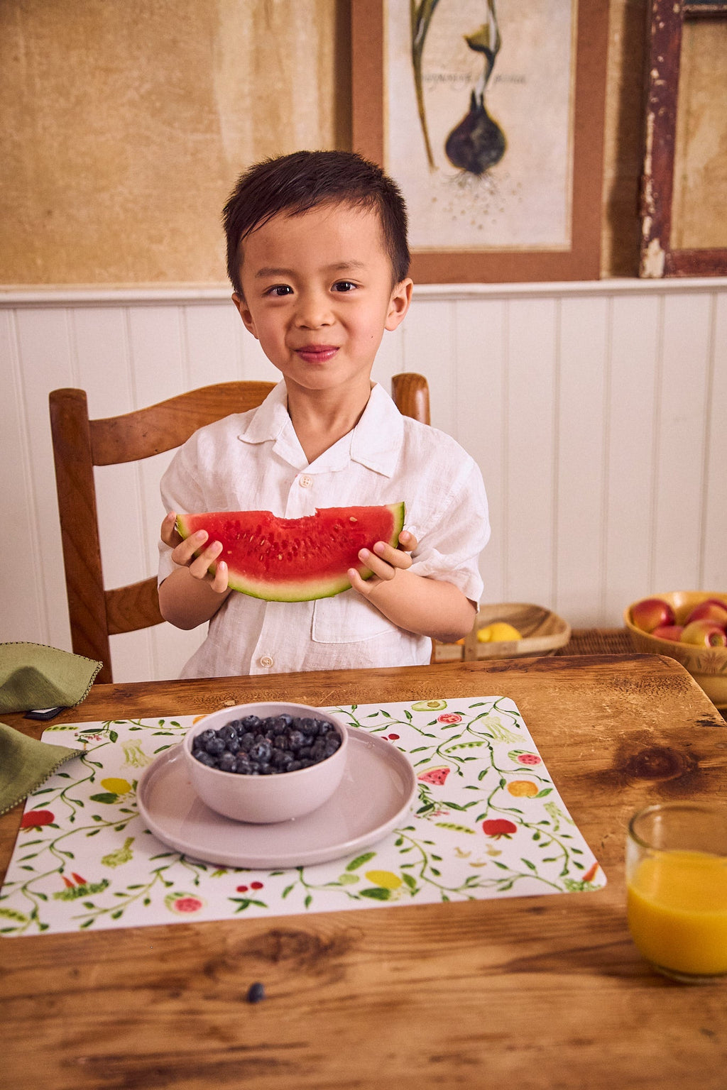 boy eating fruit on eco-friendly tableware