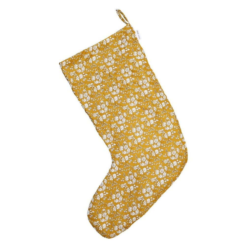 Front view of Christmas stocking in Capel Mustard Liberty fabric with white floral pattern on white background
