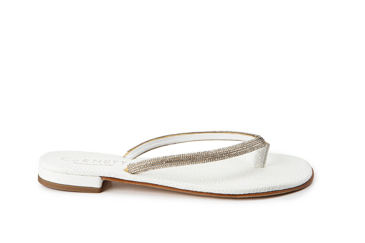 Side view of Pogliano sandal in white showcasing rhinestone-studded thong straps and low stacked heel on white background
